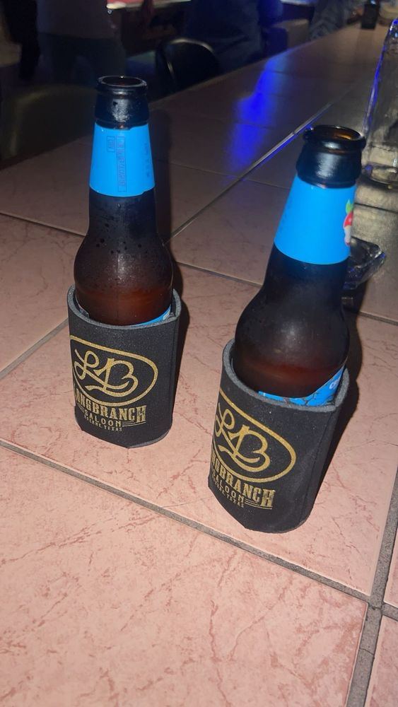 Two cold beers in Longbranch koozies on the bar