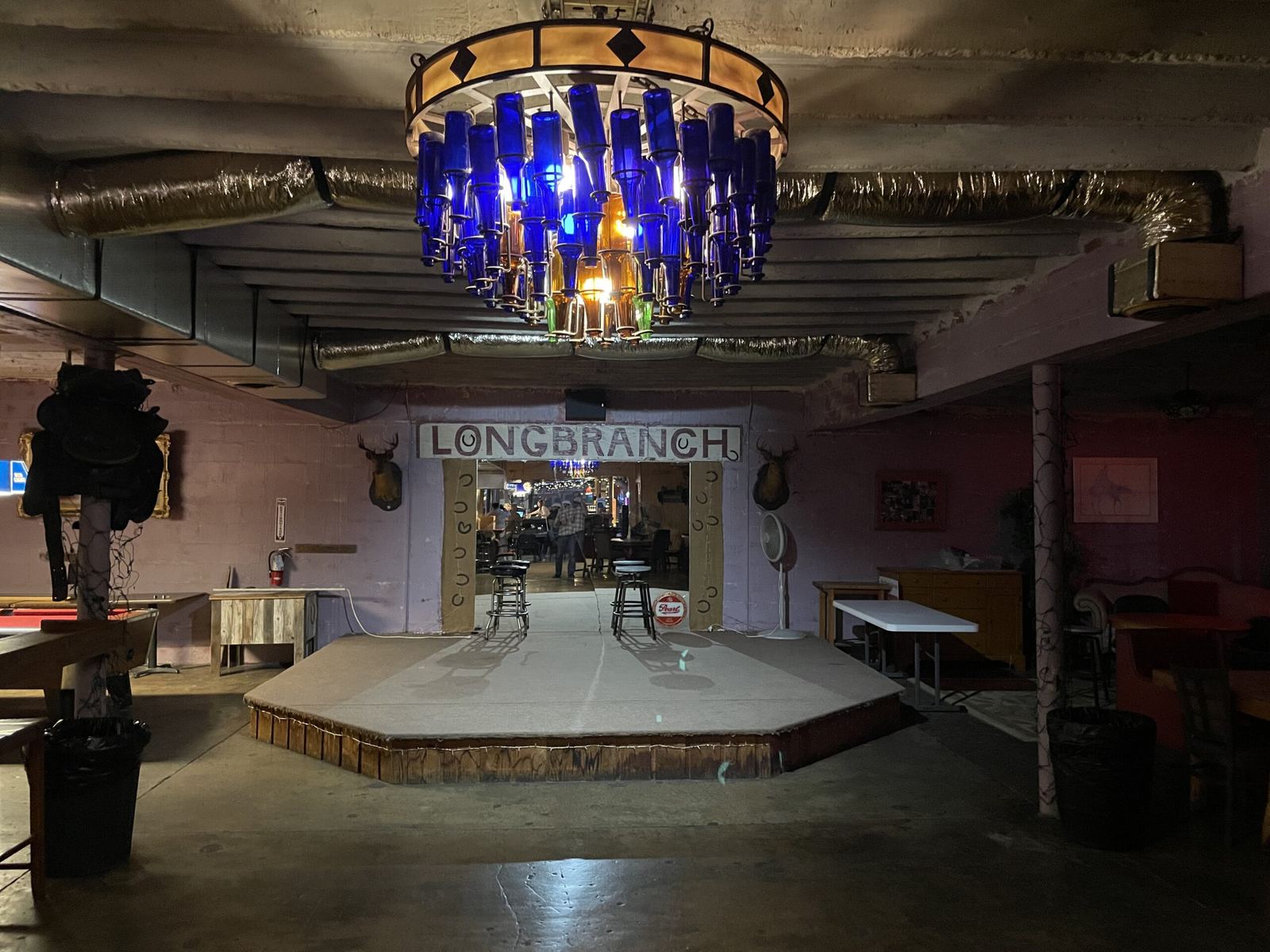 The back room stage under the blue bottle chandelier