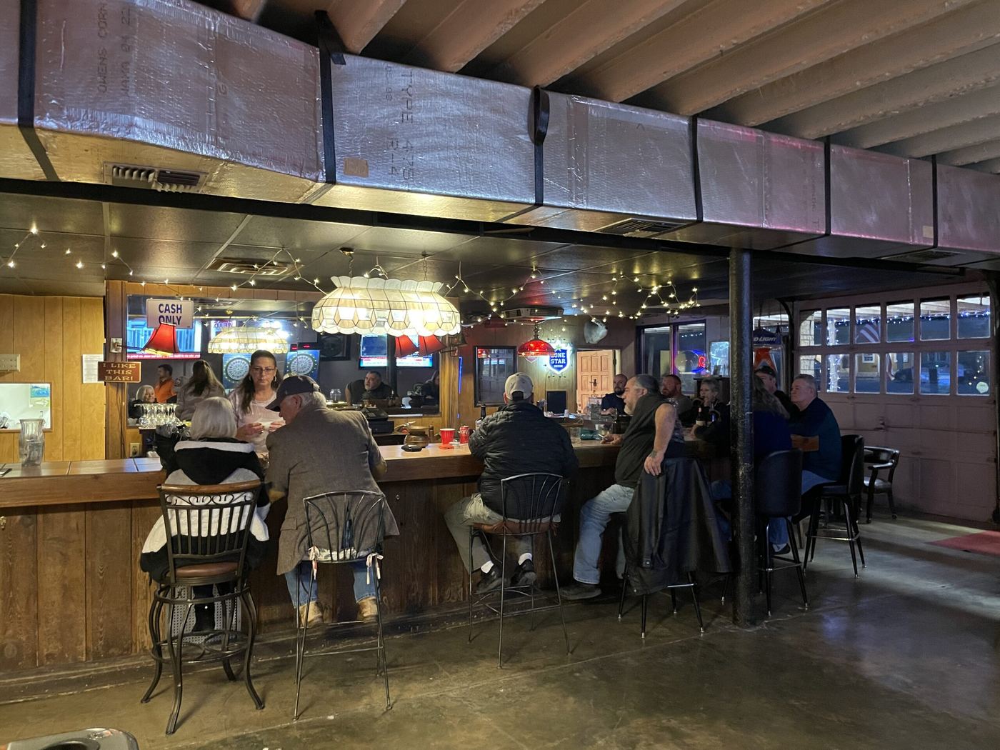 Regulars along the three-sided wooden bar